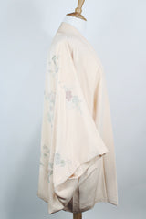 Women's vintage 1960's traditional kimono robe jacket in a pale pink color. Silk material with floral embroidery throughout. 