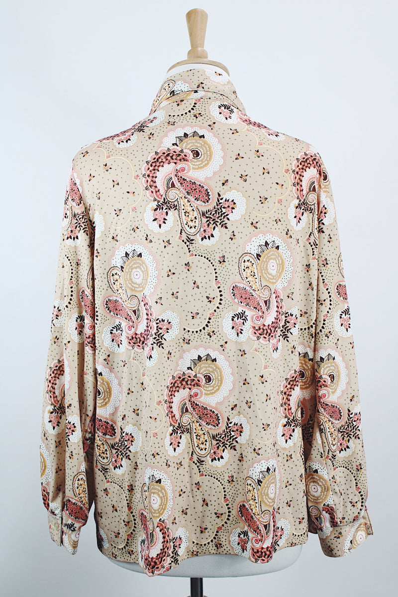 Women's vintage 1970's Stephanie, K by Koret label long sleeve button up blouse with small dagger collar in tan color and all over pale pink paisley print.