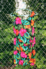 Women's vintage 1980's LA Belle, Made in USA label sleeveless mini dress in black with all over multicolored tropical floral print. Wrap tie detail in the front