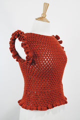 Women's vintage burnt orange acrylic crochet sweater top. Sleeveless with ruffles trim on shoulders. Has a short fit.
