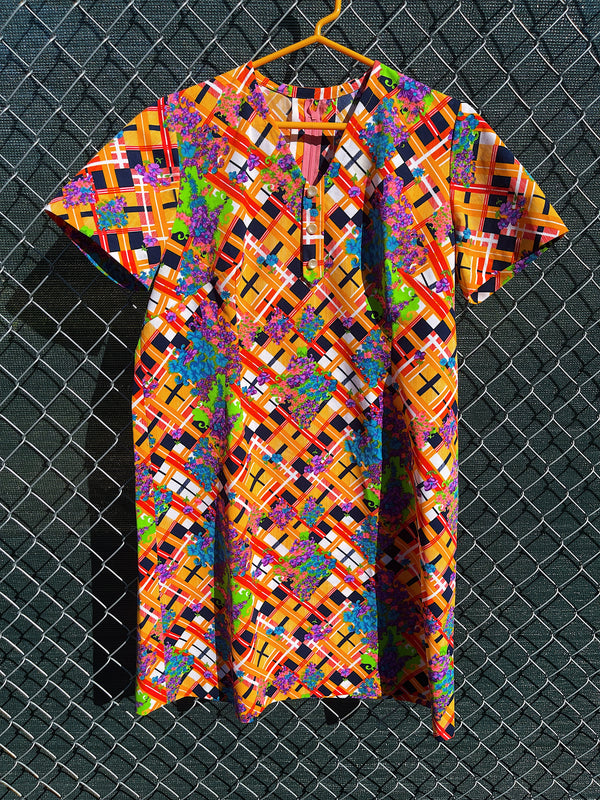 Women's vintage 1970's short sleeve mini length multicolored shift dress in polyester with v shaped neckline. 