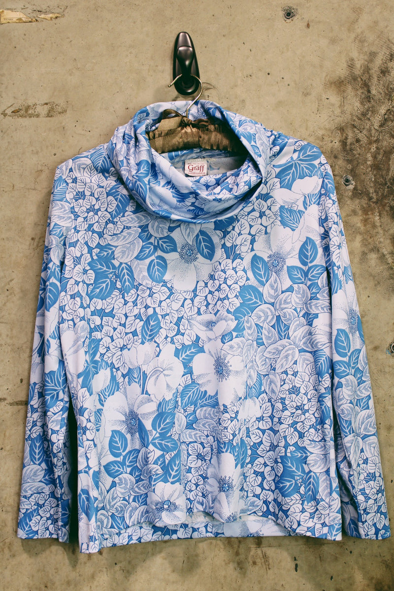 Women's vintage 1970's Graff Californiawear label long sleeve top with a cowl neck and all over blue floral print. 
