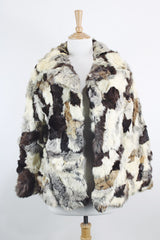 Women's vintage 1970's long sleeve multicolored patchwork genuine fur coat with hook and eye closures in the front. Grey, brown, cream, and black colors