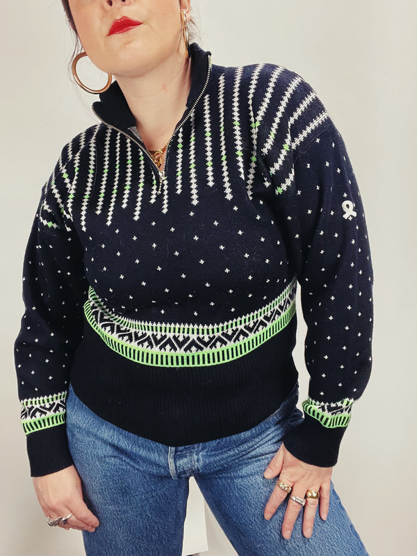 Women's vintage 1980's Demetre label long sleeve black pullover ski sweater with a half zip closure and white and green print all over. 