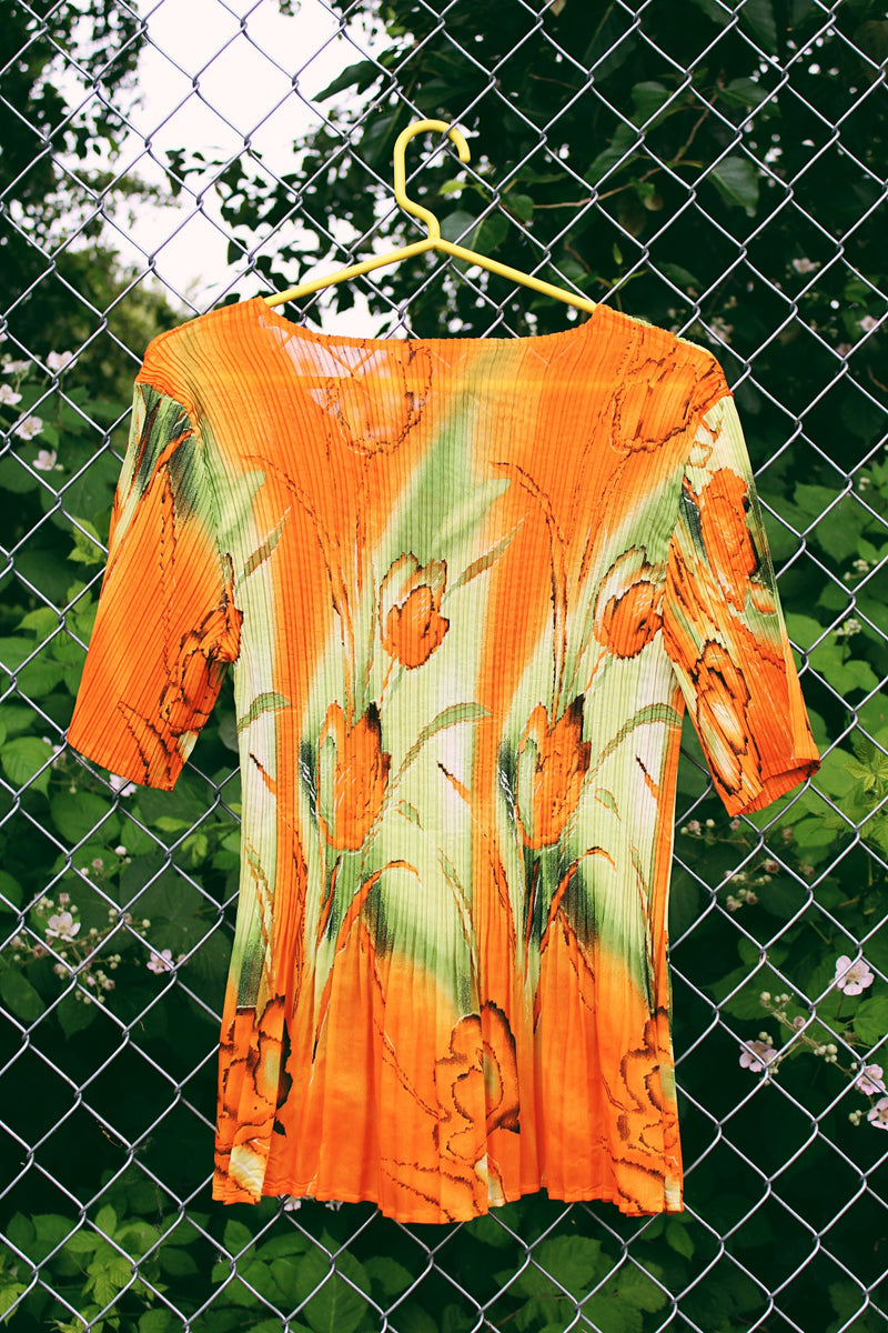 Women's vintage Y2k short sleeve bright orange tightly pleated scrunchy blouse top with a green abstract print.