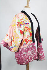 Women's vintage 1970's long sleeve puffy kimono jacket with all over multicolored patchwork print. Open front and square shaped arms.