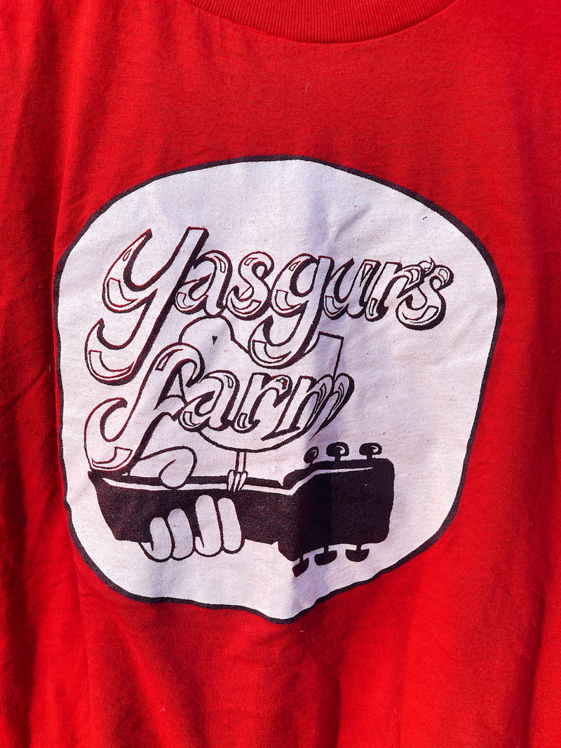 Women's or men's vintage 1970's Screen Stars, Made in the USA label short sleeve red graphic t-shirt with Yasgur's Farm logo which is the farm where Woodstock took place. 