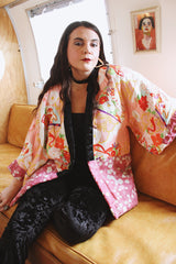 Women's vintage 1970's long sleeve puffy kimono jacket with all over multicolored patchwork print. Open front and square shaped arms.