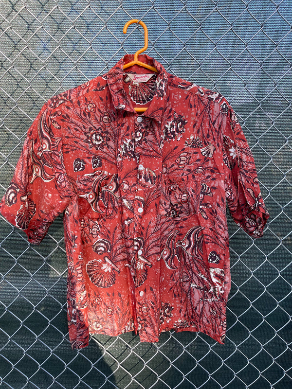 Men's vintage 1950's/1960's Leonardo label short sleeve button up rayon shirt in brown color with all over fish and seashell print. 