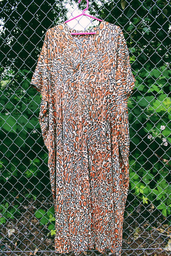 Women's vintage 1970's short sleeve maxi length muu muu kaftan dress in an all over leopard print in a polyester material. 
