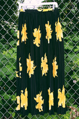 Women's vintage 1990's Anthony Mark Hankins label midi length black skirt with all over bright yellow flower. Tight pleats throughout with a stretchy elastic waistband. 