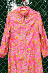 Women's vintage 1970's Bellariva label long sleeve ankle length button up shirt dress with collar. All over pink and orange floral print. 