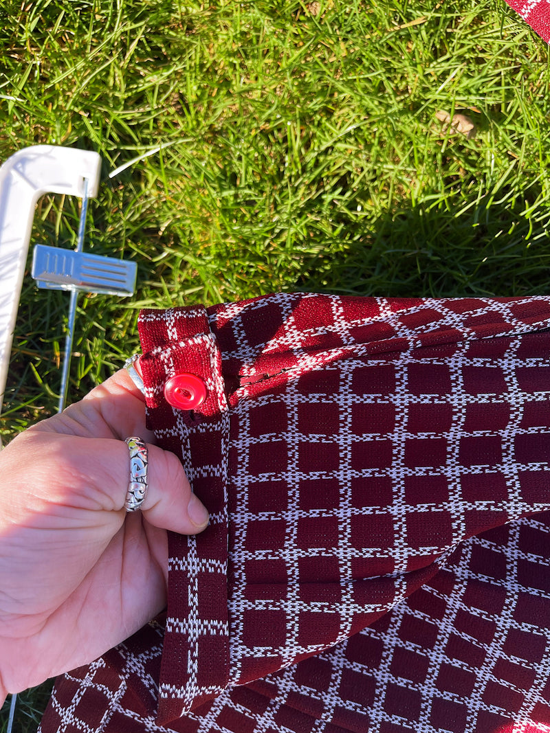 Women's vintage 1970's matching pant set with pants and a short sleeve button up shirt in maroon and white checkered print. 