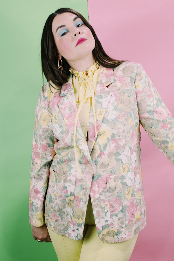 Women's vintage 1980's Elizabeth Williams, Made in USA label long sleeve floral print blazer with one button closure. All over pink, yellow, and tan flowers.