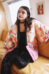 Women's vintage 1970's long sleeve puffy kimono jacket with all over multicolored patchwork print. Open front and square shaped arms.