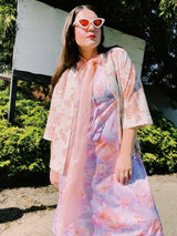 Women's vintage 1980's sleeveless midi length nightie dress in light purple, pink, and peach all over tie dye print. Has lace trim.
