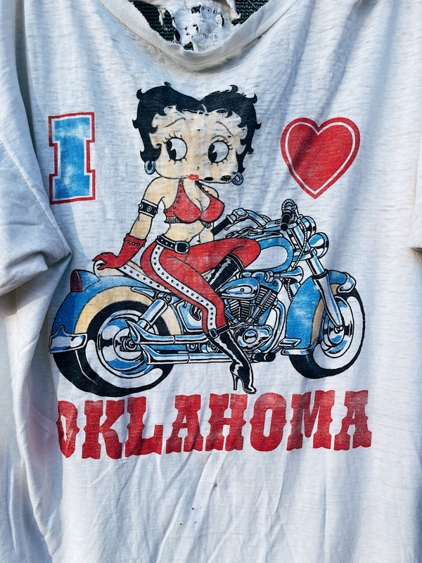 Women's or men's vintage 1980's Star California, Made in Chile label XL short sleeve white graphic t-shirt with Betty Boop on a motorcycle on the front. 