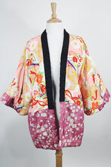 Women's vintage 1970's long sleeve puffy kimono jacket with all over multicolored patchwork print. Open front and square shaped arms.