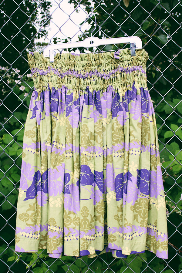 Women's vintage 1980's T & L Muu Muu Factory, Made in Hawaii label green and purple floral Hawaiian print mini skirt with a stretchy ruched waistband.