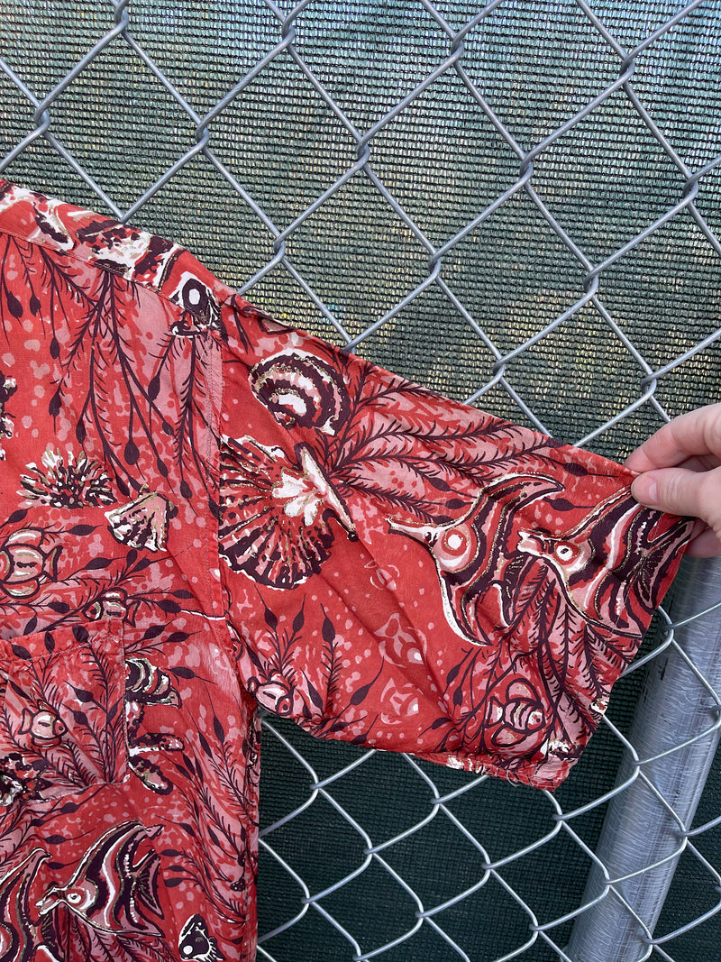 Men's vintage 1950's/1960's Leonardo label short sleeve button up rayon shirt in brown color with all over fish and seashell print. 