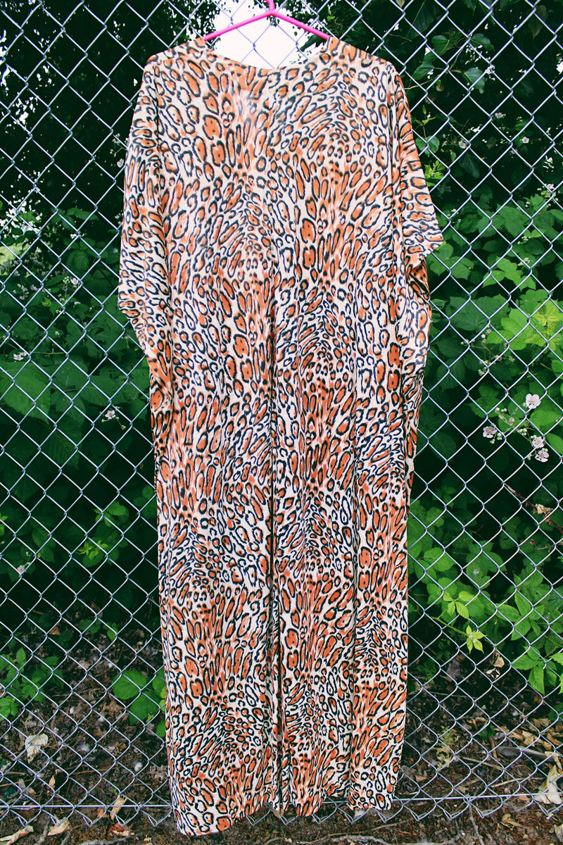Women's vintage 1970's short sleeve maxi length muu muu kaftan dress in an all over leopard print in a polyester material. 