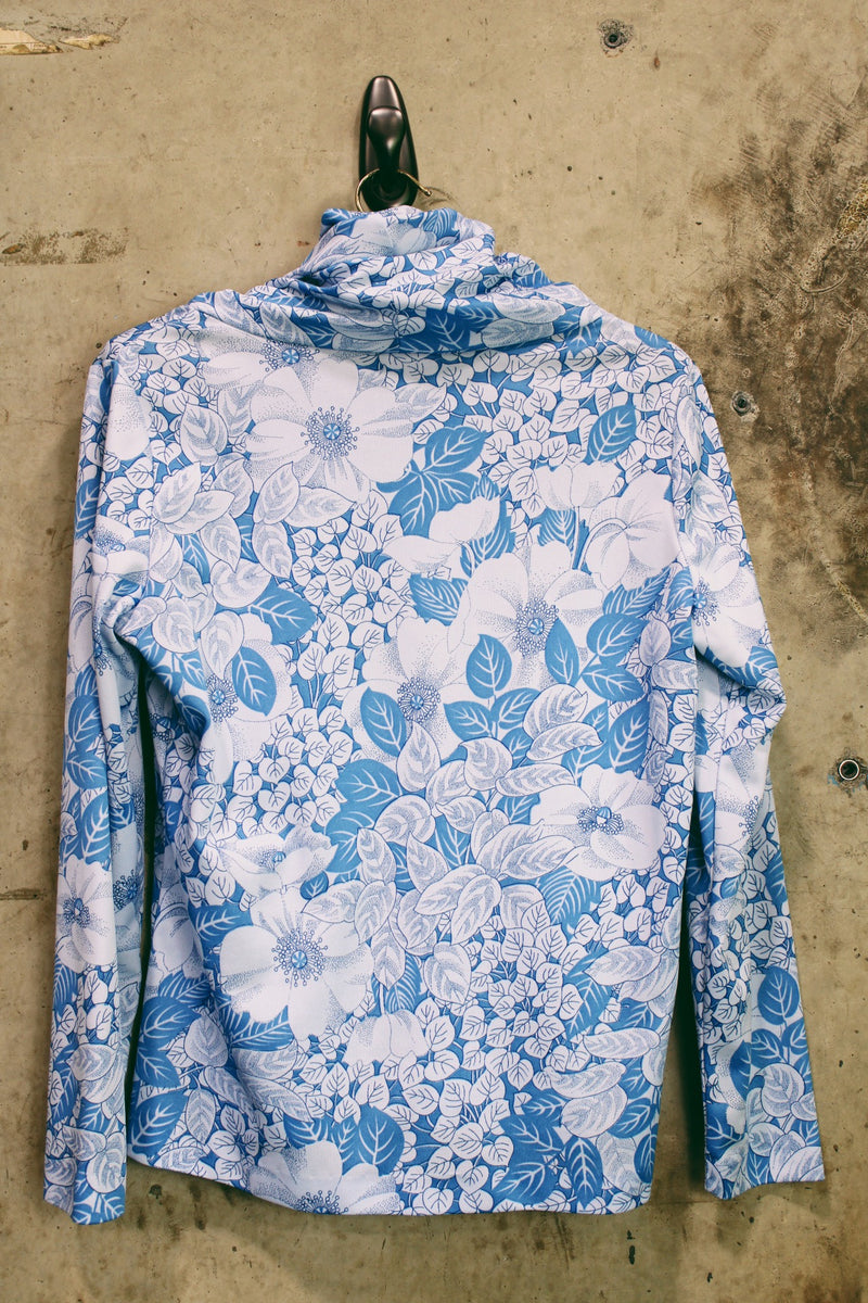 Women's vintage 1970's Graff Californiawear label long sleeve top with a cowl neck and all over blue floral print. 