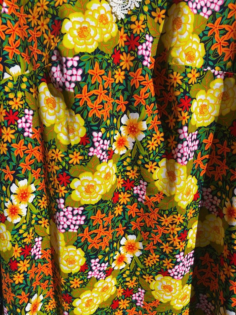 Women's vintage 1970's short sleeve mini length multicolored floral printed dress in polyester with lace trim collar. 
