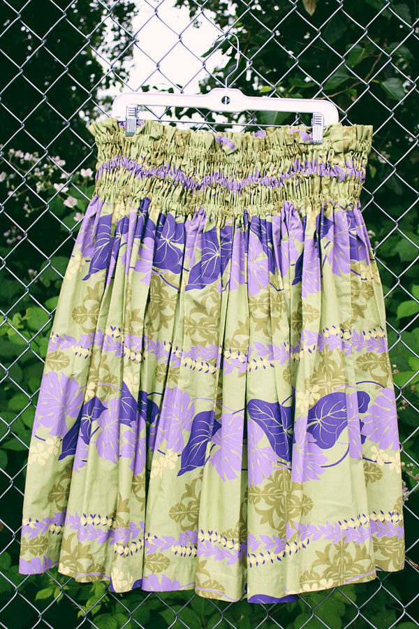 Women's vintage 1980's T & L Muu Muu Factory, Made in Hawaii label green and purple floral Hawaiian print mini skirt with a stretchy ruched waistband.