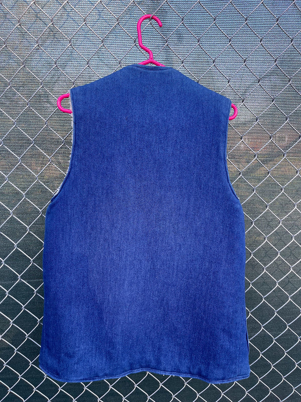 Men's or women's vintage 1970's sleeveless blue denim open front vest with cream shearling liner and pockets. 