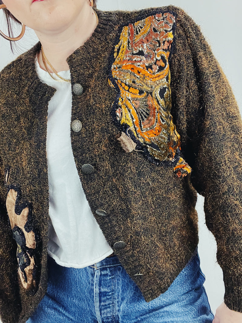 Women's vintage 1980's long sleeve brown orange wool cardigan with brass buttons and two abstract patches in the front. 