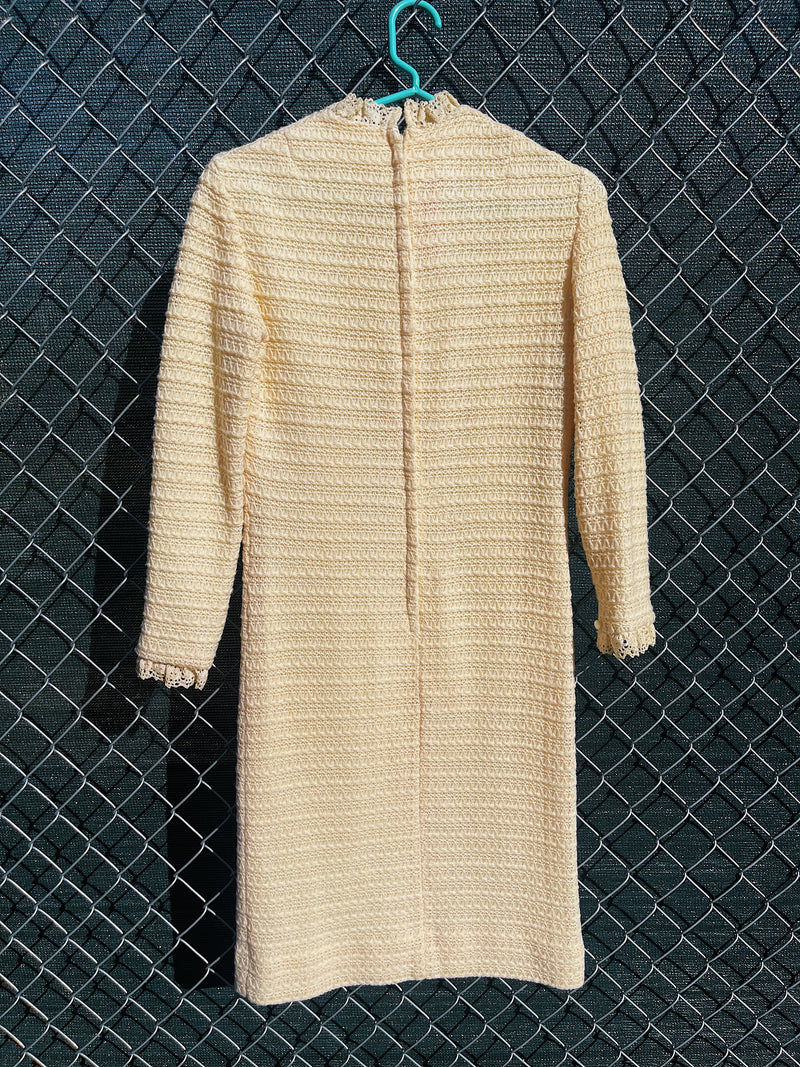 Women's vintage 1970's Maggi label long sleeve short length cream colored crochet dress with lace trim and mock neck. 