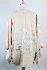 Women's vintage 1960's traditional kimono robe jacket in a pale pink color. Silk material with floral embroidery throughout. 
