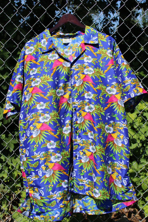Men's vintage 1990's Island Shirtworks label short sleeve button up Hawaiian print shirt in blue with all over parrot print in a lightweight Polyester material. 