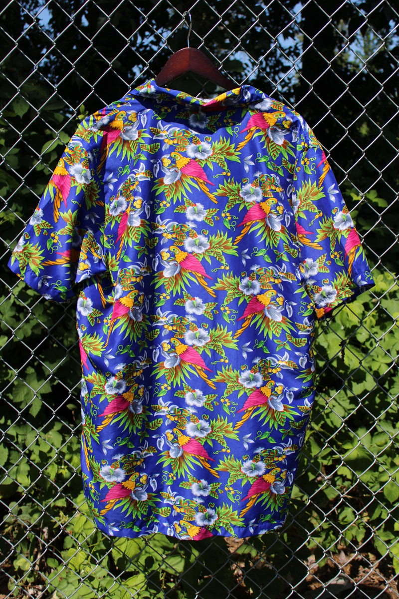 Men's vintage 1990's Island Shirtworks label short sleeve button up Hawaiian print shirt in blue with all over parrot print in a lightweight Polyester material. 