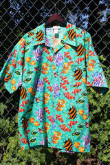 Men's vintage 1980's CPR ZIN, USA label short sleeve button up Hawaiian print shirt in turquoise with an all over fish print in a cotton material. 