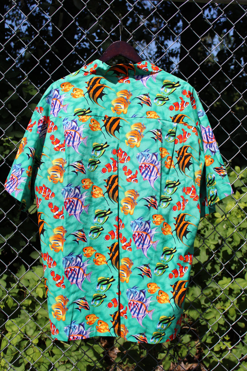 Men's vintage 1980's CPR ZIN, USA label short sleeve button up Hawaiian print shirt in turquoise with an all over fish print in a cotton material. 