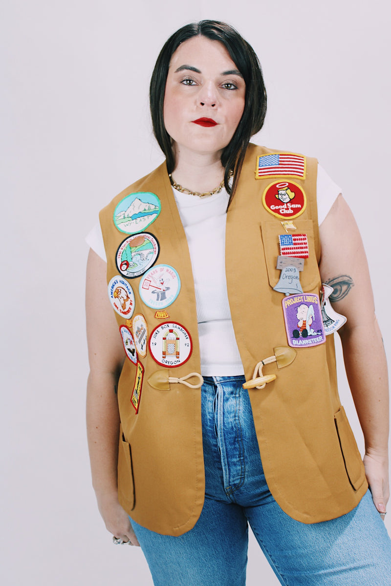 beige brown sleeveless vest with toggle button and patches all over