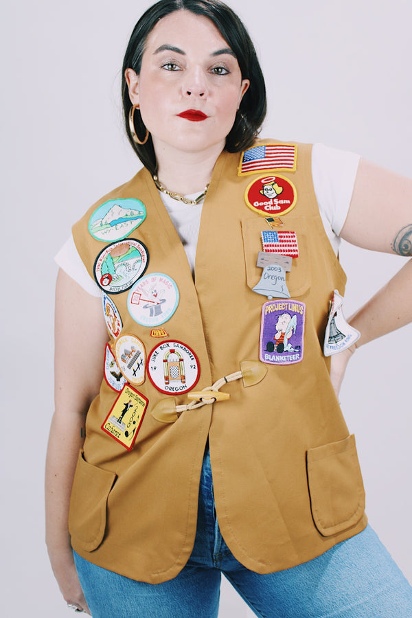 beige brown sleeveless vest with toggle button and patches all over