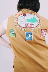 beige brown sleeveless vest with toggle button and patches all over