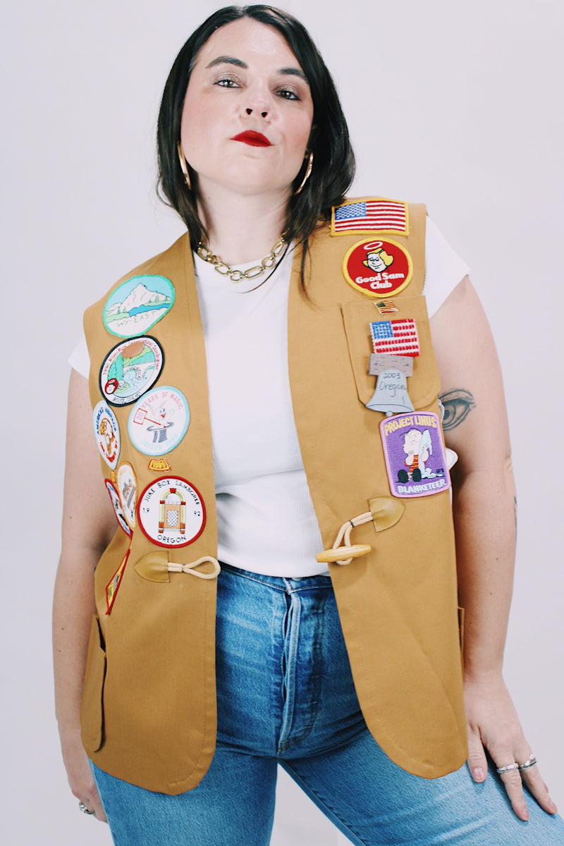 beige brown sleeveless vest with toggle button and patches all over