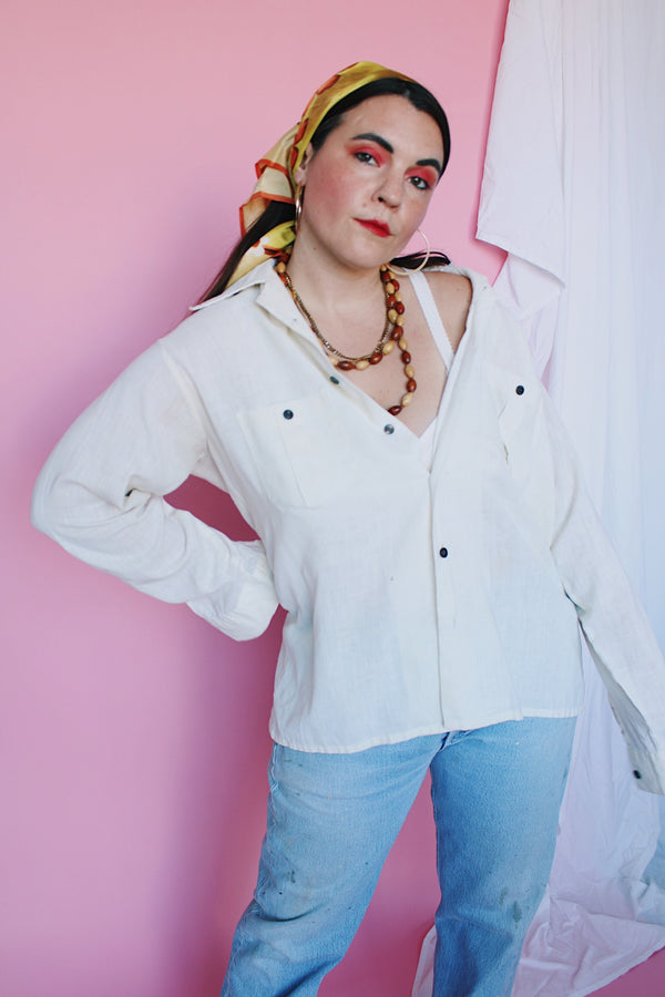 Men's or women's vintage 1970's Montgomery Ward label long sleeve cream colored cotton material button up shirt. Brown buttons and two chest pockets.