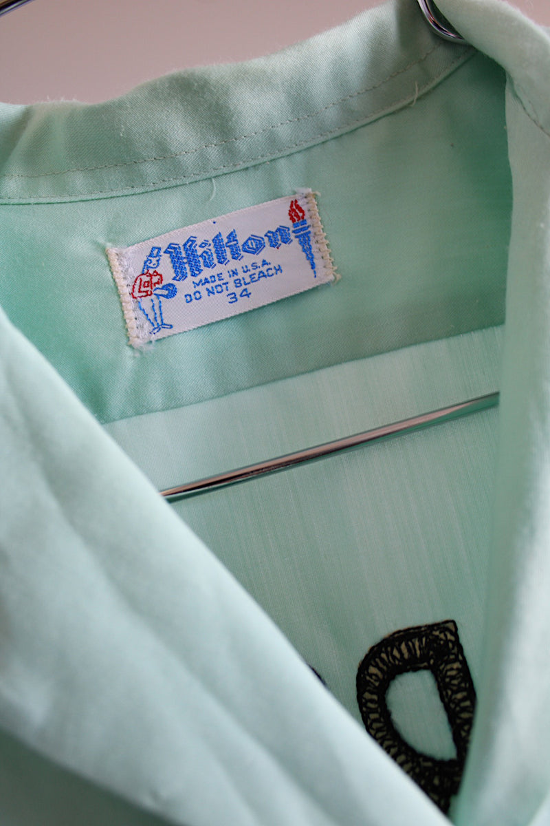 Women's vintage 1960's Hilton, Made in USA label short sleeve teal colored cotton button up blouse with collar and front pocket.