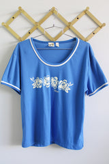 Women's vintage 1970's Liki Liki, Honolulu, Hawaii label short sleeve blue t-shirt with white Hawaii graphic on the front and white trim in polyester material. 