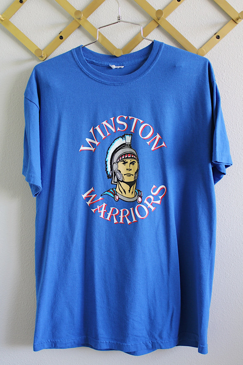 Women's or men's vintage 1990's short sleeve bright blue tee in size large in cotton material. Graphic on the front of Winston, Oregon high school mascot Winston Warriors.