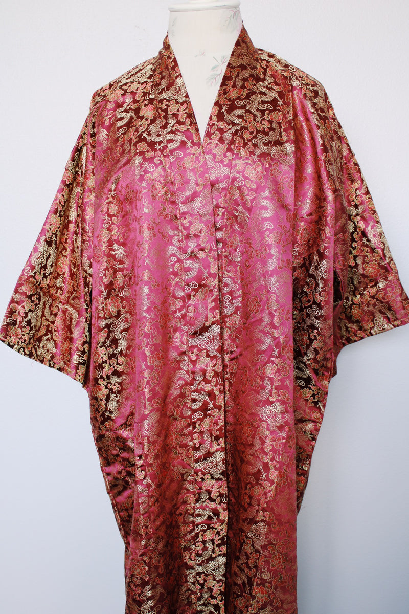 Women's vintage 1970's long sleeve long length maroon colored kimono robe jacket. Gold all over print. Front pockets and comes with matching tie belt.