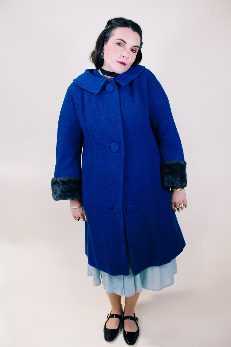 Women's vintage 1960's Jack Bloom California label long sleeve royal blue color coat. Ankle length with grey fur trim around collar and cuffs.