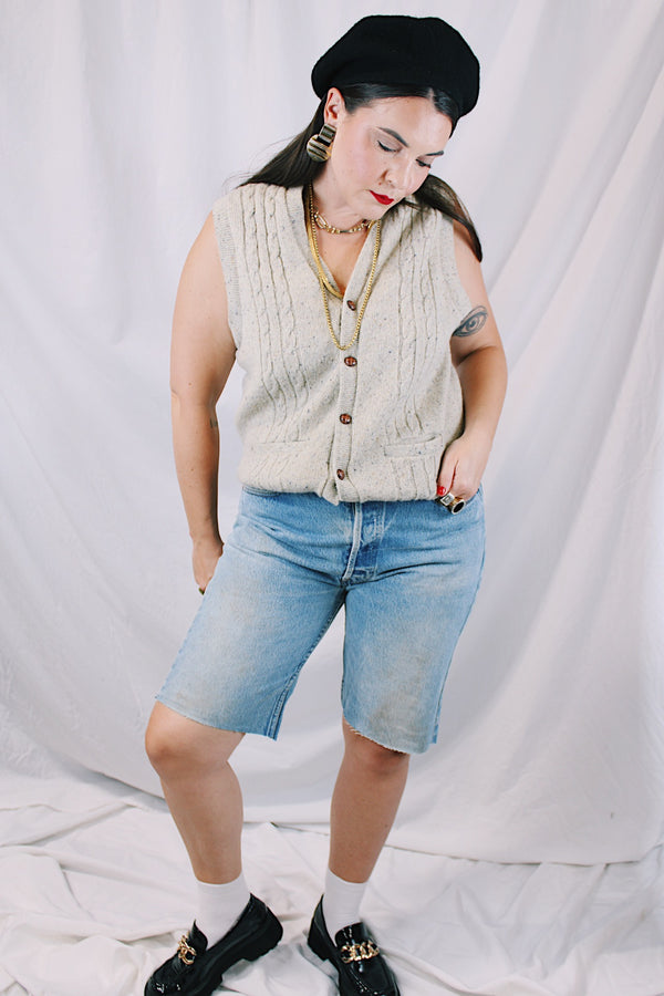 Men's or women's vintage 1970's Jantzen, Made in USA label sleeveless button up sweater vest cardigan in a wool and acrylic material. Oatmeal color with navy speckles and a cable knit texture. 