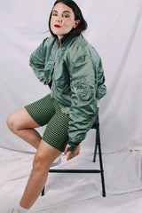Men's or women's army zip up bomber jacket with long sleeves. Army green color with orange satin liner. Reversible.
