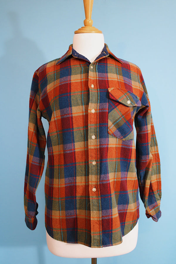 Men's or women's vintage 1970's Lobo, Pendleton label long sleeve button up shirt in a wool material in a tan, blue, and burn orange plaid print. 