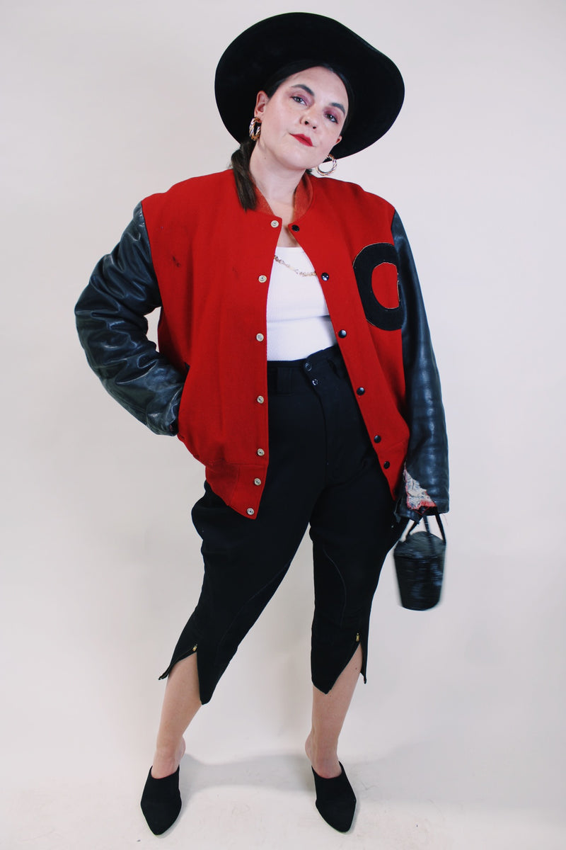 Men's or women's vintage 1970's De Long Sportswear Classics label long sleeve letterman bomber jacket with red wool body and black leather arms.